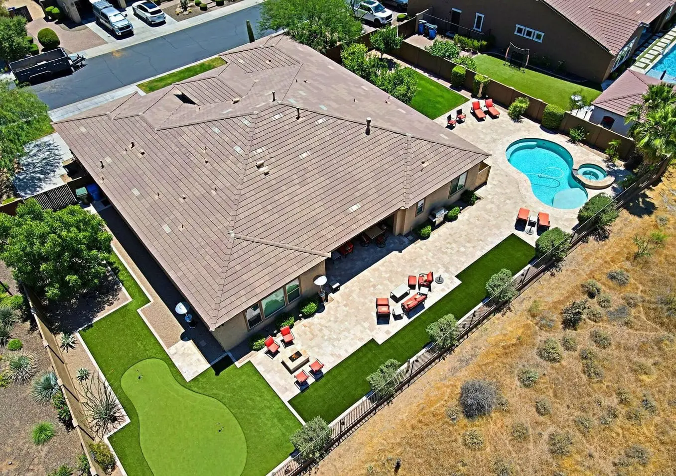 birds eye view of a home in Surprise AZ with a travertine paver patio and pool deck installed by Surprise Artificial Grass Co.