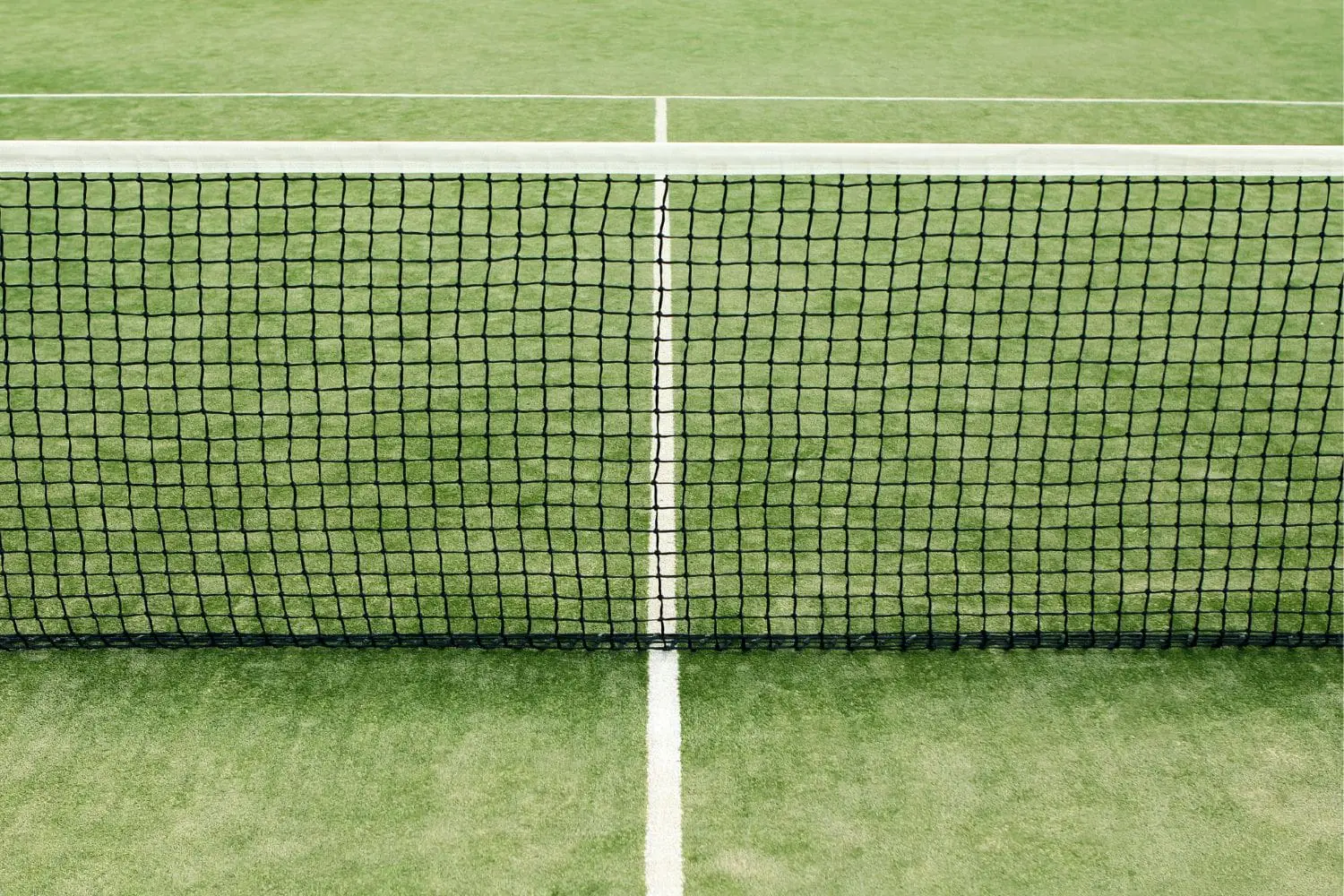 A synthetic grass pickleball court with the net in the center of the shot. Installed by Surprise Artificial Grass Co in Surprise AZ