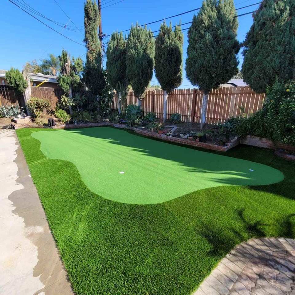 An image of a golf green at a home in Surprise Arizona. It has 3 holes and a fringe area. Installed by Surprise Artificial Grass Co who are putting green contractors specializing in artificial grass.