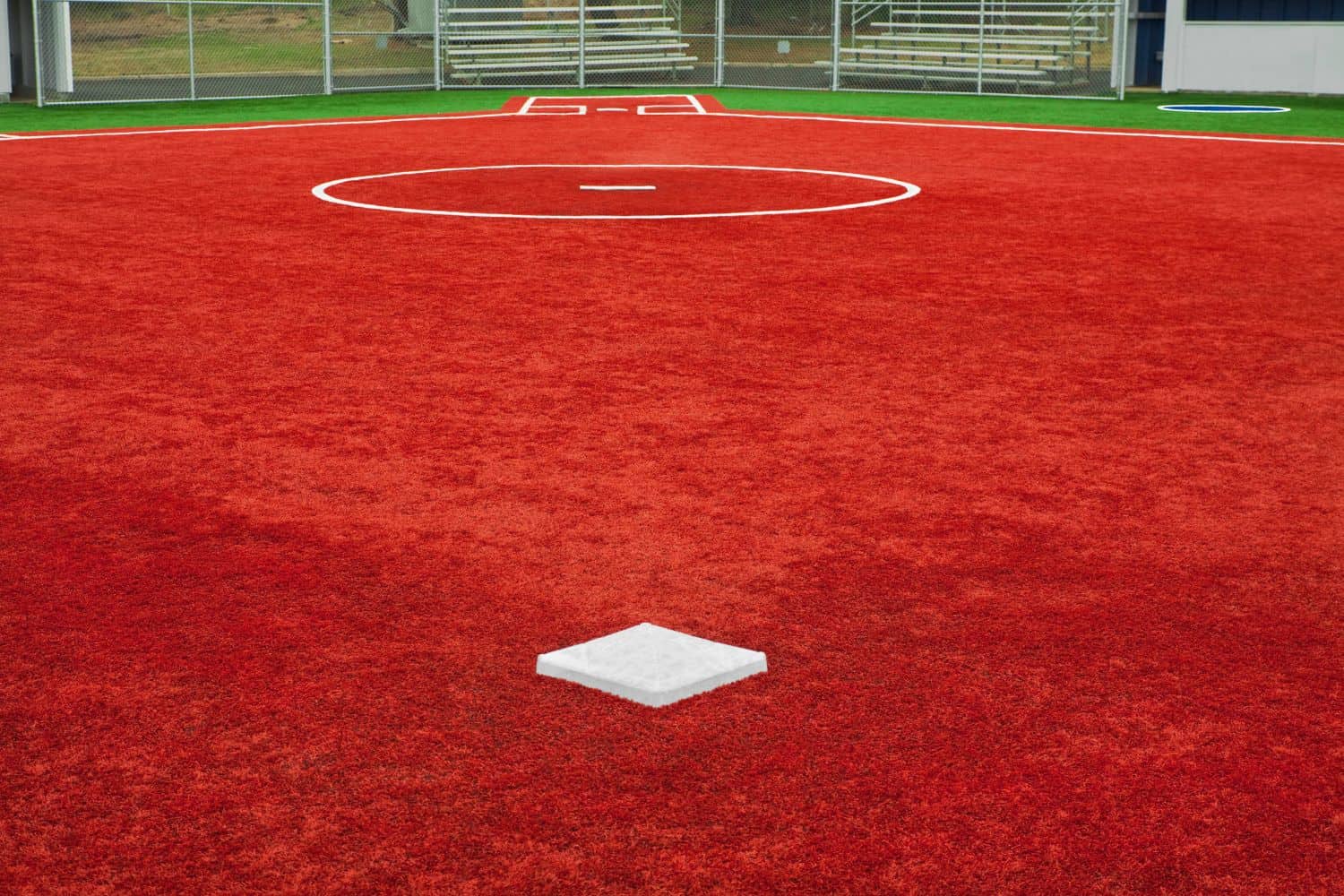 A synthetic softball field installed by Surprise Artificial Grass Co in Surprise AZ. Has red turf infield and green turf outfield